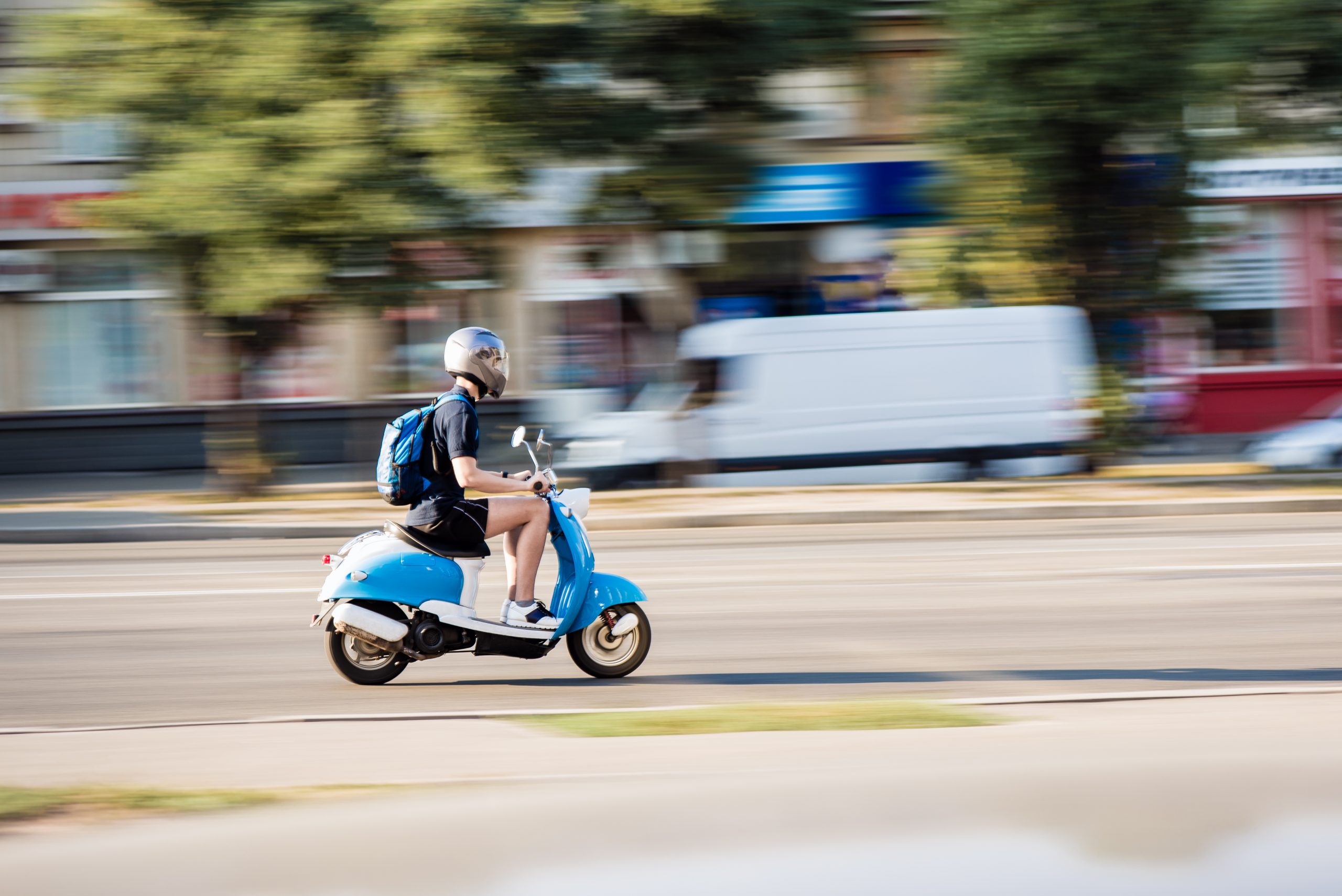 Motion Blurred moped moving past the camera